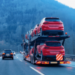 auto transport carrying several vehicles on highway