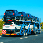cars transported by a transfer truck
